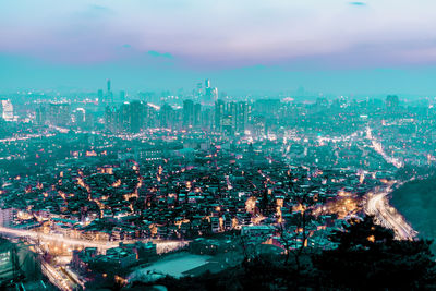 High angle view of illuminated cityscape against sky