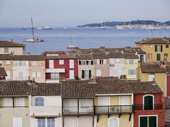 Residential district by sea against sky