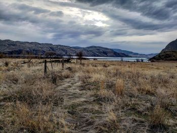 Scenic view of land and mountains against sky