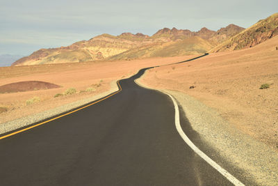 Road amidst landscape against sky