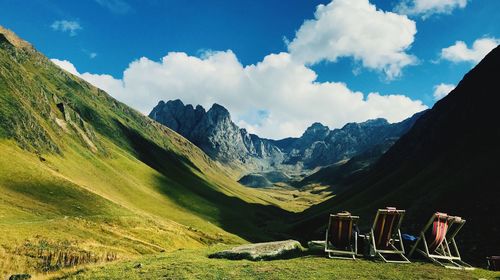 Panoramic view of field and mountains against sky