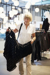 Mature woman in clothes shop