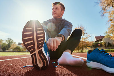 Runner get ready for run, tying sneakers shoelaces