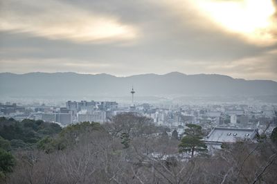 Cityscape against cloudy sky