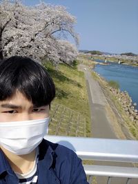 Portrait of young man against sky