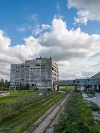 View of buildings in city against cloudy sky