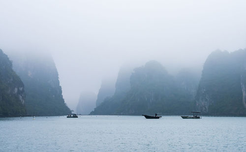 Scenic view of sea and mountains against sky