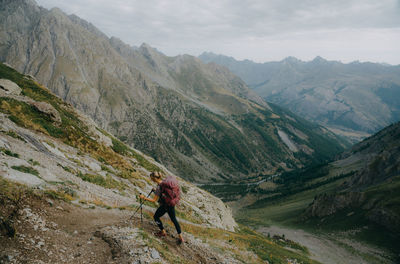 High angle view of woman climbing at mountain