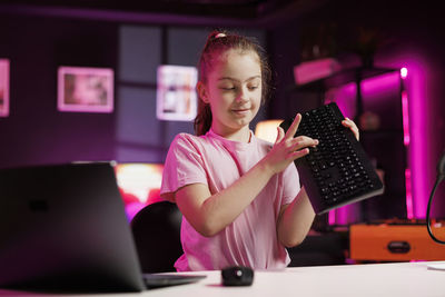 Portrait of young woman using laptop at home