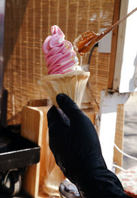 Midsection of person holding ice cream at home