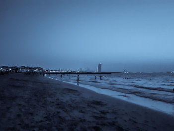 Scenic view of sea against clear sky at dusk