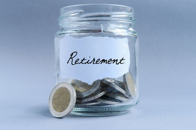 Close-up of coins on glass against white background