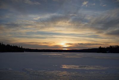 Scenic view of lake against sky during sunset