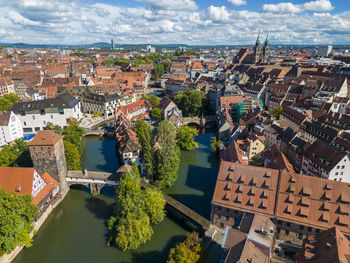 Germany, bavaria, nuremberg, pegnitz river flowing through historic old town