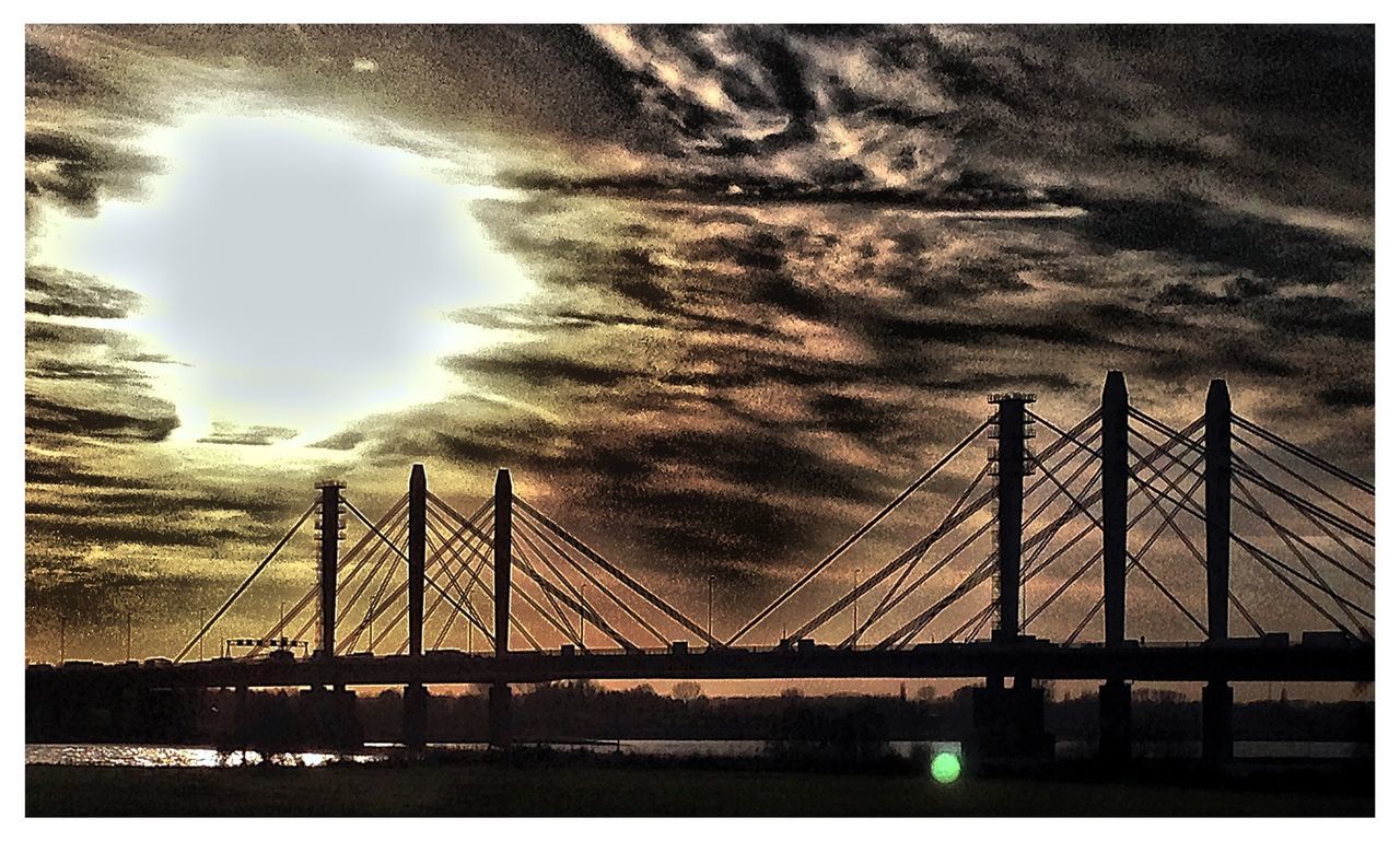 transfer print, connection, sky, water, auto post production filter, cloud - sky, built structure, bridge - man made structure, river, architecture, waterfront, cloudy, engineering, silhouette, dusk, transportation, crane - construction machinery, cloud, sunset, low angle view