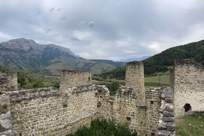 Old ruins of ancient city against sky in caucasus mountains 