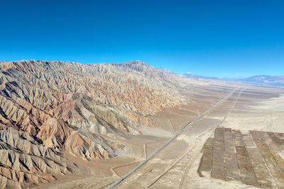 Scenic view of mountains against blue sky