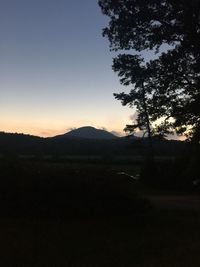 Scenic view of silhouette mountain against sky at sunset