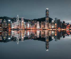 Reflection of illuminated buildings in lake at night