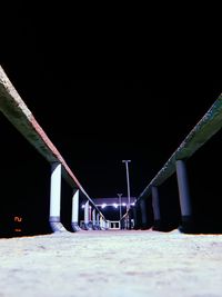 Surface level of empty chairs against clear sky at night