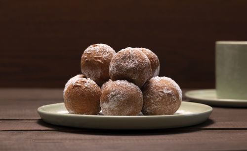 Fat thursday carnival or tlusty czwartek, christian tradition. powdered with sugar doughnut, zeppole