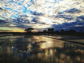 Scenic view of lake against sky during sunset