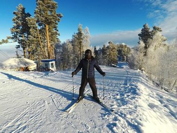 Man skiing on snow covered field during winter