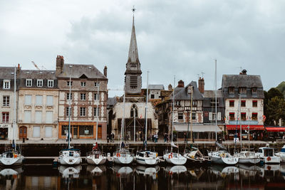 Boats moored in canal against buildings