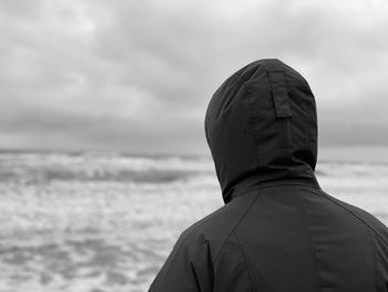 Rear view of woman in sea against sky