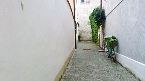 Sidewalk amidst cars on wall