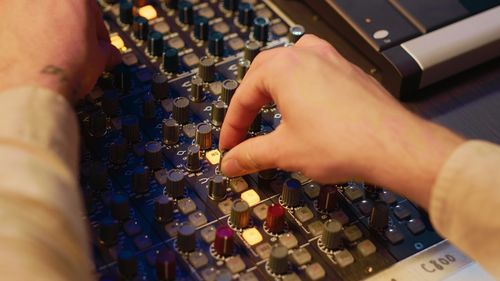 Low section of woman using sound mixer