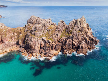 Panoramic view of rock formation in sea against sky