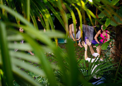 Meditation workshop for women in a green garden with tropical plants