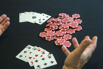 Close-up of man playing poker on table