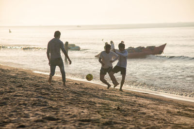 Rear view of people on beach