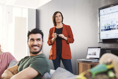 Mature businesswoman with colleagues in meeting at office