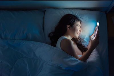 Young woman sleeping on bed at home