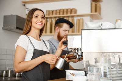 Young woman having food in kitchen