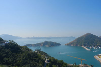 High angle view of sea and mountains against clear sky
