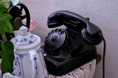 High angle view of teapot telephone on table