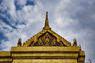 Low angle view of temple building against cloudy sky