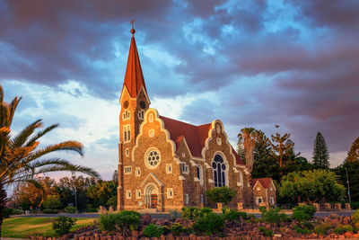 View of temple building against cloudy sky