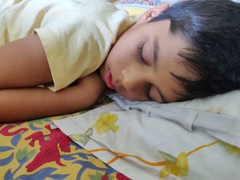 High angle view of baby sleeping on bed