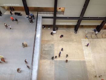 High angle view of people walking in corridor