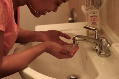 Cropped image of woman holding cigarette