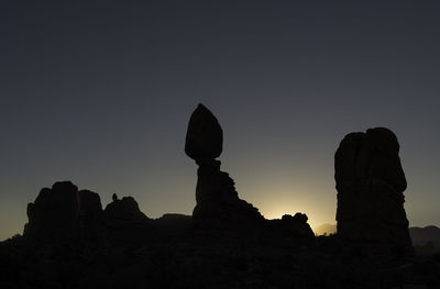 Low angle view of rock formation against sky during sunset