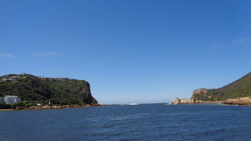 Scenic view of sea against clear blue sky