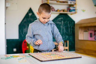 Boy playing on table at home