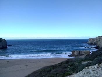 Scenic view of sea against clear blue sky