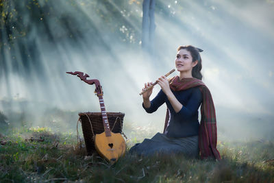 Young woman sitting on field